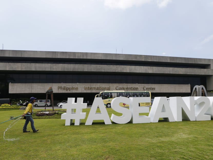 A worker waters the lawn of the Philippine International Convention Centre, the venue for the 30th Asean Leaders' Summit. Photo: AP