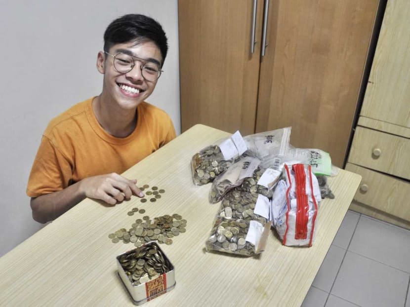Nanyang Technological University undergraduate Adrian Foo with a pile of five-cent coins donated to his initiative, which is raising money to buy meals for needy seniors.