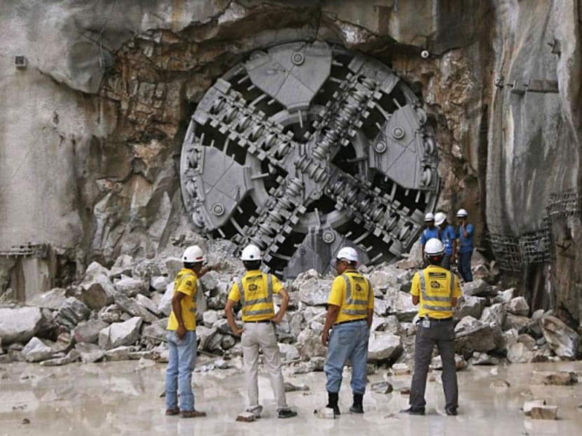 Engineers in front of a Tunnel Boring Machine, which was used in the construction of the Klang Valley Mass Rapid Transit (MRT) line. Major projects covered in 11MP include the MRT and Third Light Rail Transit. Photo: The Malay Mail