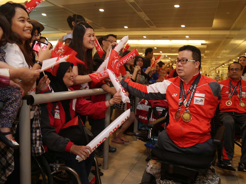 Singaporean para-table tennis player Jason Chee being greeted by supporters as he arrives at Changi Airport on Sunday (Sept 24). Chee won his first-ever individual Asean Para Games title in Kuala Lumpur last Friday. Photo: Wee Teck Hian/TODAY