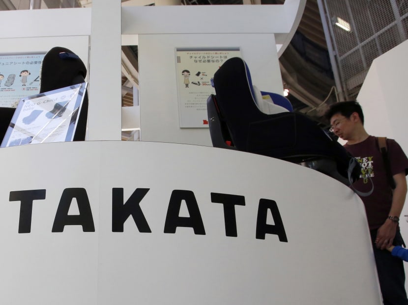 In this May 4, 2016 file photo, visitors look at child seats, manufactured and displayed by Takata Corp. at an automaker's showroom in Tokyo.  Photo: AP
