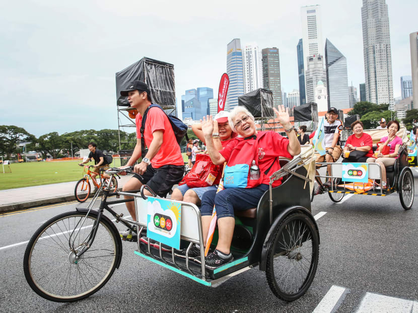 An elderly couple being ferried in a trishaw as part of Car-Free Sunday SG in November  2016, as they enjoy the sights around the Civic District Loop. Photo: Nuria Ling/TODAY
