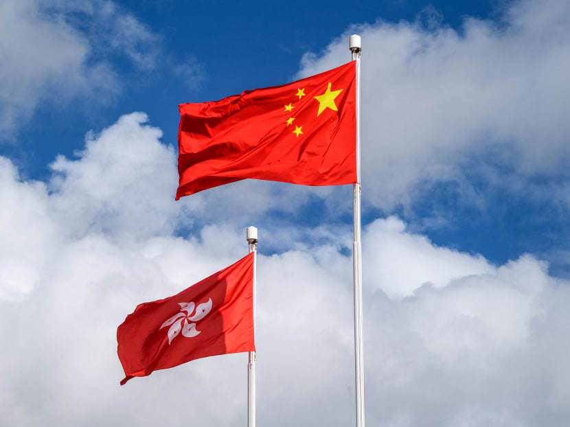 The Chinese (right) and Hong Kong (left) flags are seen hoisted at the end of a flag-raising ceremony to mark the 23rd anniversary of Hong Kong's handover from Britain in Hong Kong on July 1, 2020.