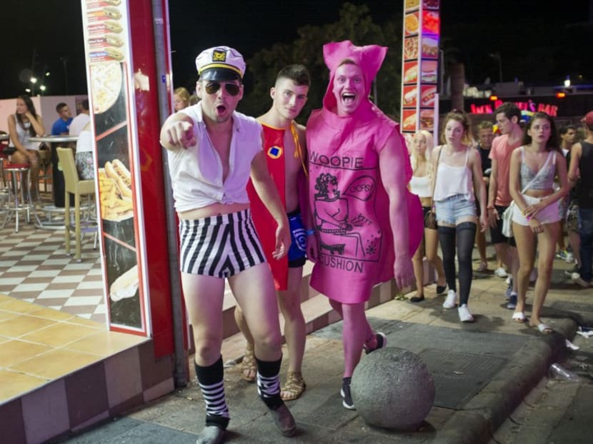 British tourists pose in Punta Ballena street as they have fun in the Magalluf zone, in Calvia on Mallorca Island. AFP file photo
