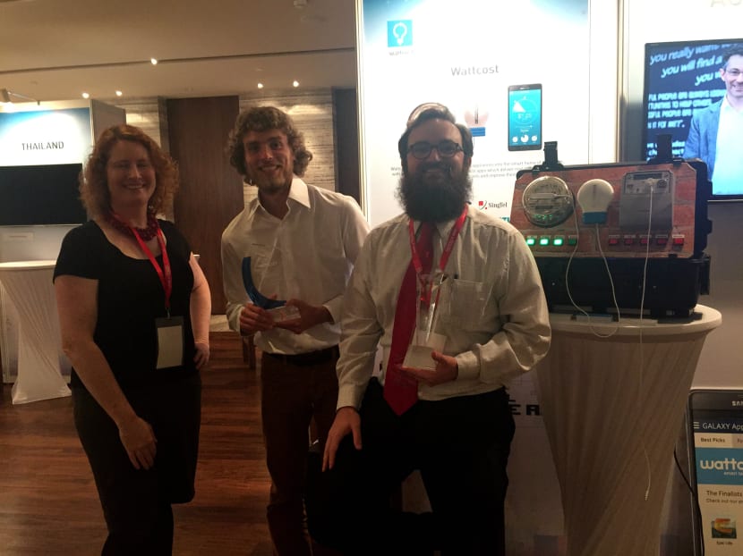 Wattcost's Mary Cudmora (left),Tell Muller-Pettenpohl (centre) and Demetrious Harrington (right) posing beside the wireless beacon used for the Wattcost app, which won the Singtel Group-Samsung Mobile App Challenge. Photo: Elgin Chong