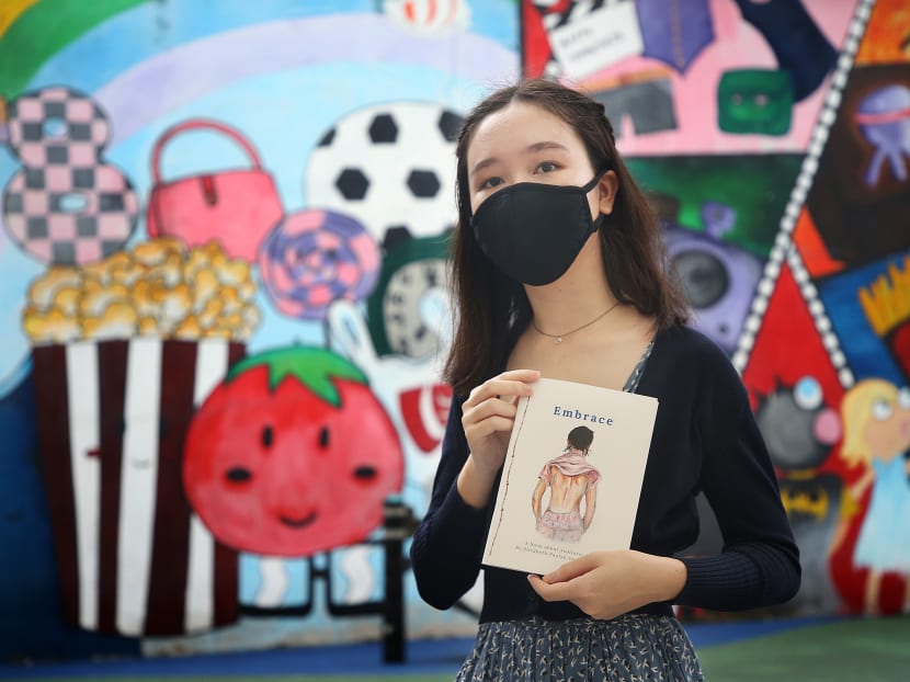 Junior college student Elizabeth Paulyn Gostelow (pictured), who braved gruelling treatments due to an uncommon spine condition, has written a book titled Embrace in the hope of giving comfort to other sufferers. Junior college student Elizabeth Paulyn Gostelow (pictured), who braved gruelling treatments due to an uncommon spine condition, has written a book titled Embrace in the hope of giving comfort to other sufferers.