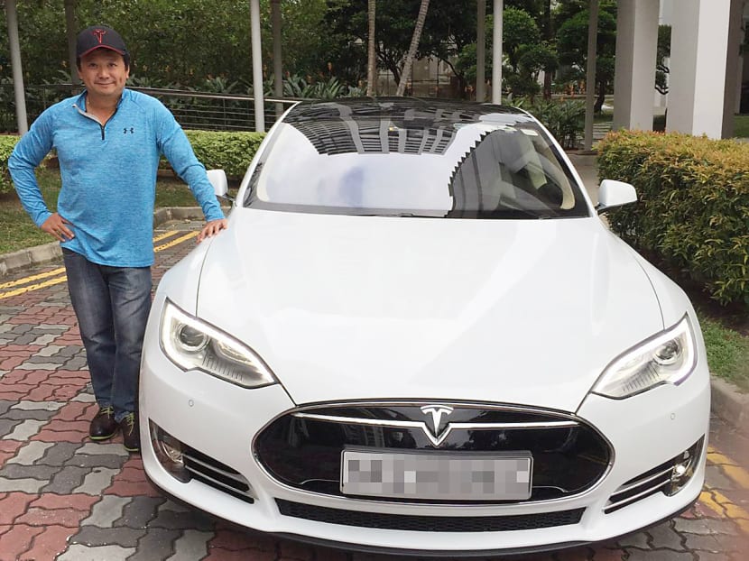 Mr Joe Nguyen with his Tesla Model S. Mr Nguyen welcomed a re-test of his car under ‘proper supervision’, and said it was very unlikely a 1.5 year-old car with 1,000km would lose that kind of efficiency. Photo: Joe Nguyen