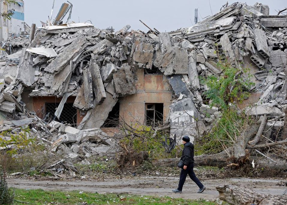 A man walks past the ruins of a building destroyed in the course of the Russia-Ukraine conflict, in Mariupol, Russian-controlled Ukraine on Nov 9, 2022. 
