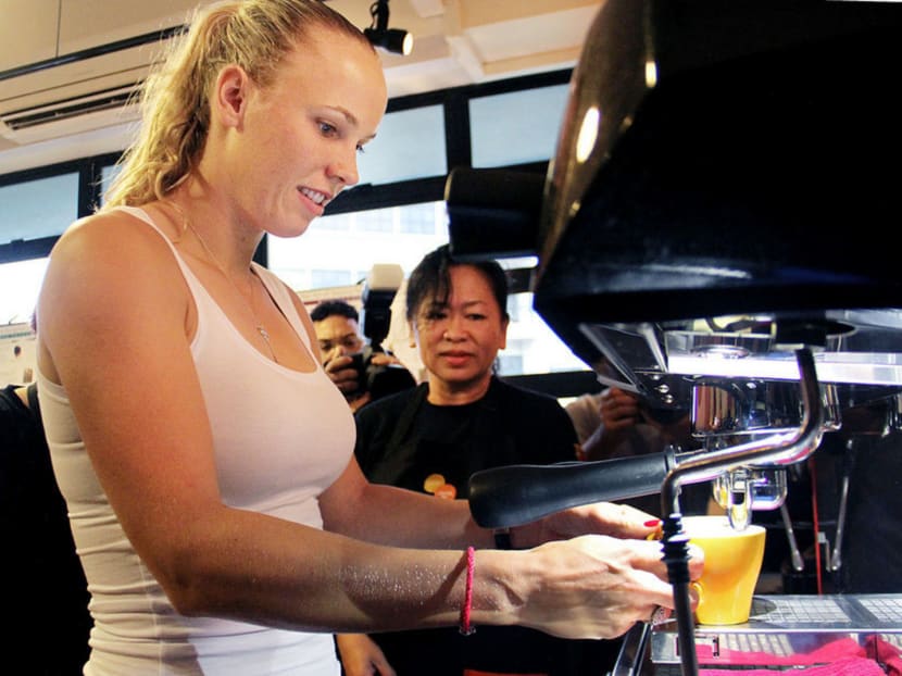 Wozniacki trying her hand at brewing coffee and learning the secrets behind latte art for a day at Bettr Barista. Photo: Geneieve Teo
