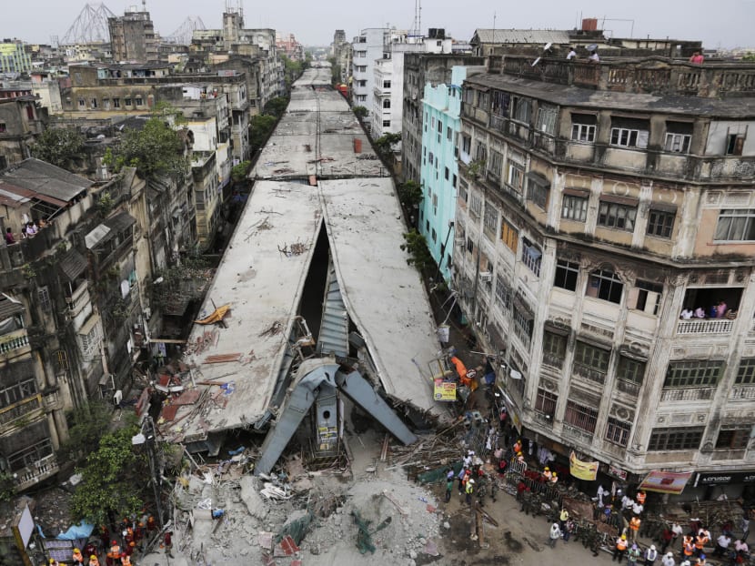 General view shows a partially collapsed overpass in Kolkata, India, Friday, April 1, 2016. The overpass spanned nearly the width of the street and was designed to ease traffic through the densely crowded Bara Bazaar neighborhood in the capital of the east Indian state of West Bengal. Photo: AP