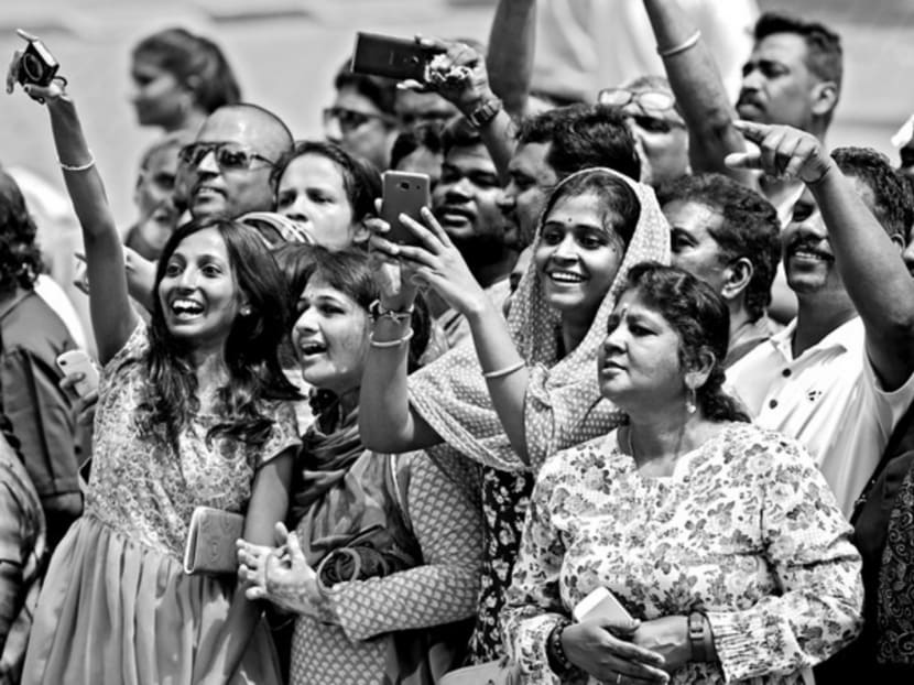 Onlookers cheering the arrival of Mr Modi in a Kuala Lumpur suburb yesterday. Mr Modi has turned to the Indian diaspora as a springboard to deepening his regional power base. Photo: Reuters