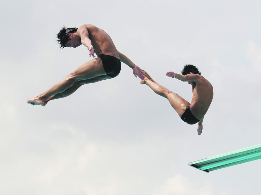 National divers Timothy and Mark Lee doing synchronised diving at Toa Payoh Swimming Pool.  Photo by OOI BOON KEONG.