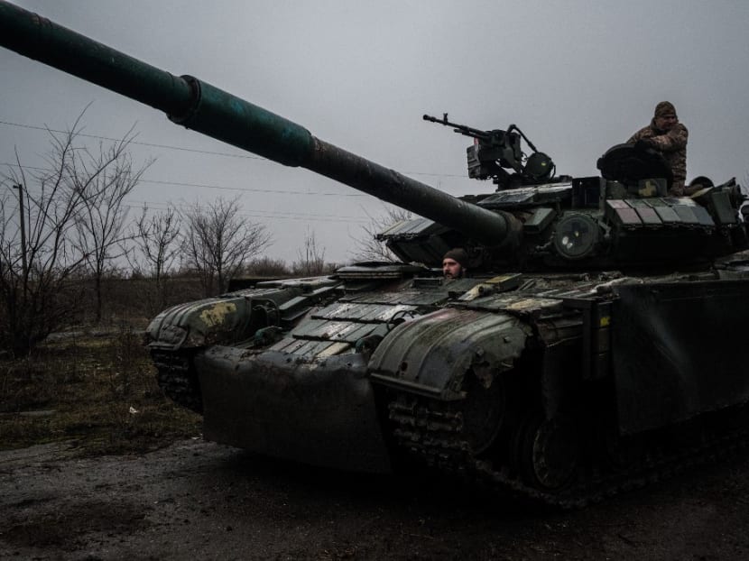 Ukrainian servicemen drive a T-64 tank along a road from the town of Chasiv Yar, Donetsk region to Bakhmut on March 9, 2023.