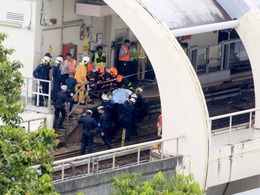 SCDF officers extricate a body from the scene of a train accident on March 22, 2016. TODAY file photo