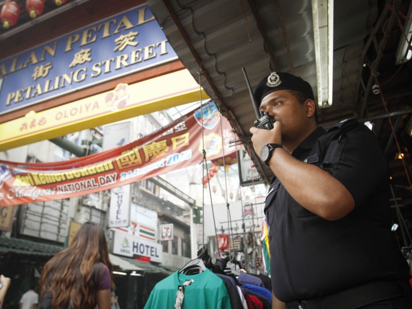 A Malaysian police stands guard at the arch of Malaysia's tourist attraction, Petaling Street in Kuala Lumpur on Sept 26, 2015. Photo: AP