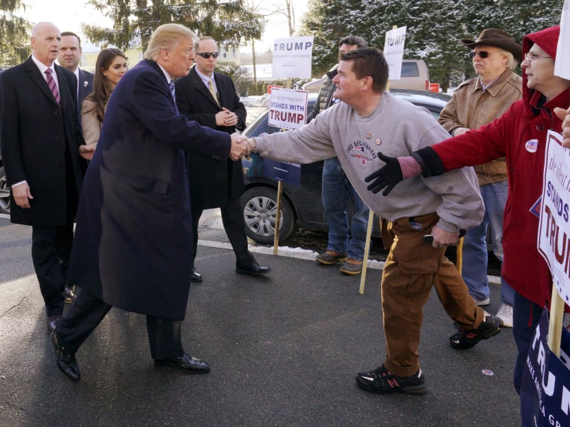 US Republican presidential candidate Donald Trump greets supporters at a polling place for the presidential primary in Manchester, New Hampshire February 9, 2016. Photo: Reuters