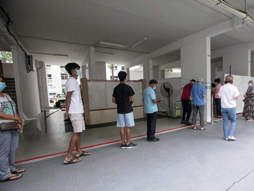 Residents of Block 506 Hougang Avenue 8 queueing to get tested for Covid-19 on May 21, 2021 at the void deck of the block.