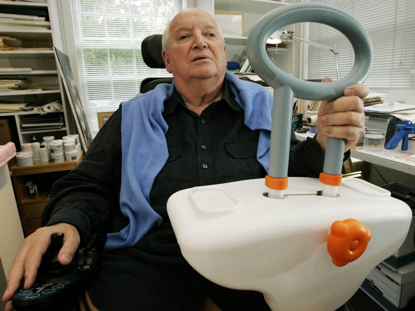 In this Sept. 11, 2009 file photo, architect and designer Michael Graves sits in his Princeton, N.J. studio holding a bathtub handle he designed to help the handicapped and elderly. Photo: AP
