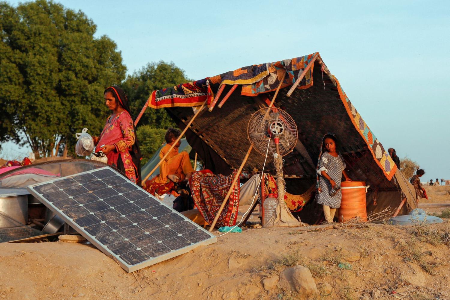 A woman and children, who became displaced, take refuge at their makeshift tent in a camp, following rains and floods during the monsoon season in Sehwan, Pakistan on Sept 15, 2022. A woman and children, who became displaced, take refuge at their makeshift tent in a camp, following rains and floods during the monsoon season in Sehwan, Pakistan on Sept 15, 2022.