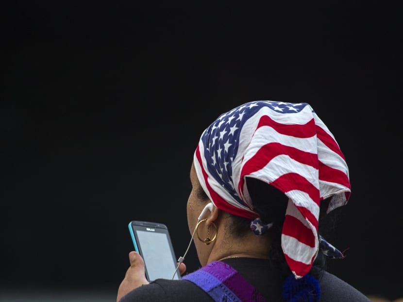 A woman uses her smartphone. AP file photo