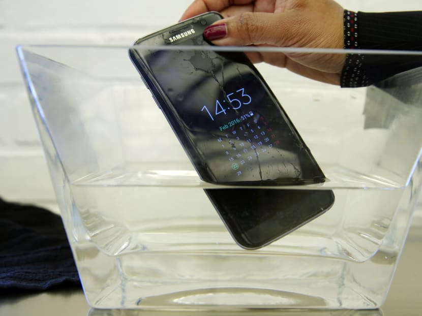 A waterproof Samsung Galaxy S7 Edge mobile phone is submersed in water during a preview of Samsung's flagship store, Samsung 837, in New York's Meatpacking District, Monday, Feb 22, 2016. Samsung is opening what it calls a "technology playground" in New York for customers to check out its latest gadgets. The center opens Tuesday, the day Samsung starts taking orders for its upcoming Galaxy S7 and S7 Edge phones. Photo: AP