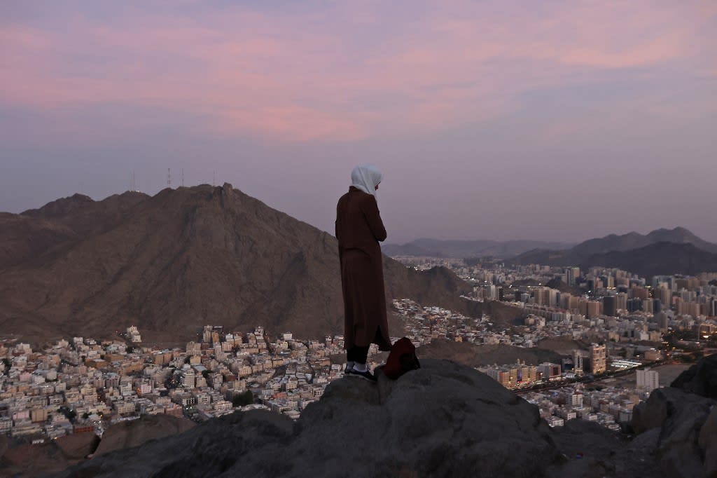 A Muslim pilgrim looks over the holy city of Mecca from atop the Jabal al-Noor or 'Mountain of Light', on July 5, 2022.&nbsp;