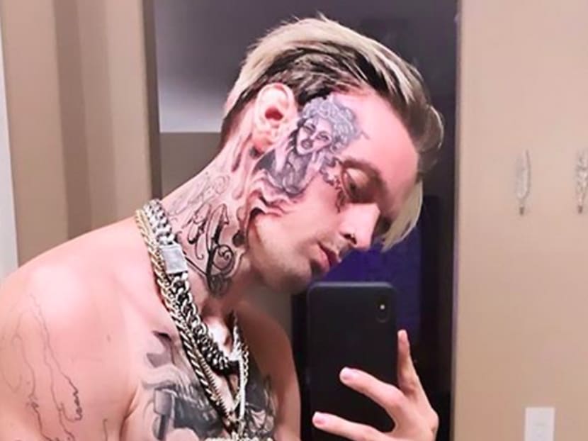 Aaron Carter reveals face tattoo after restraining order from siblings Nick and Angel Aaron Carter reveals face tattoo after restraining order from siblings Nick and Angel