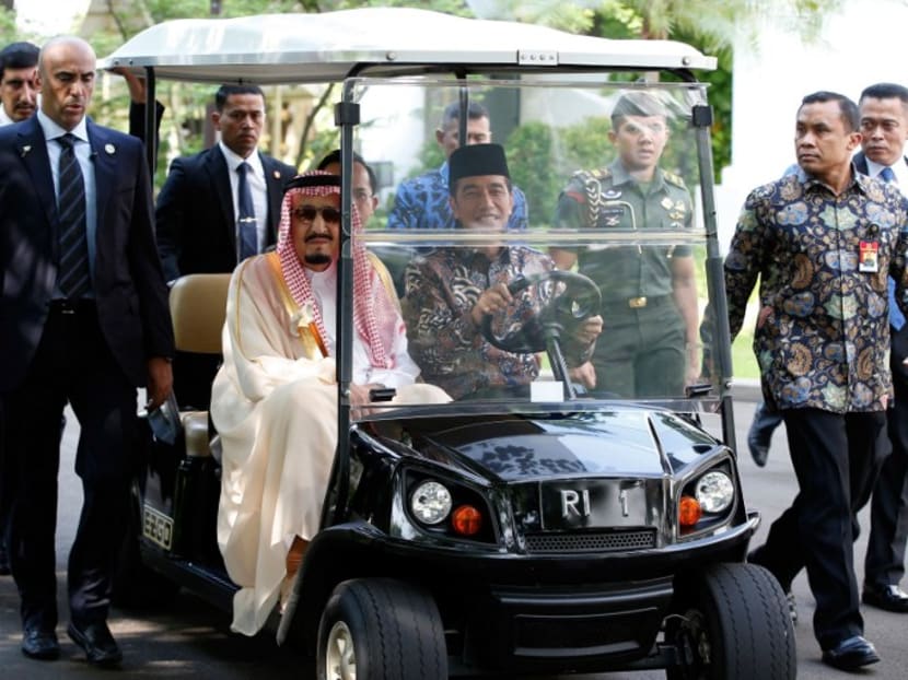 Saudi Arabia's King Salman bin Abdul Aziz being driven by Indonesian President Joko Widodo in a golf cart in the presidential palace in Jakarta on Mar 2, 2017. Photo: AFP