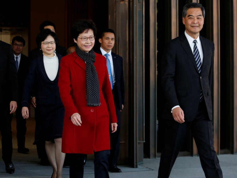 Newly elected Hong Kong Chief Executive Carrie Lam (second from left) with current leader Mr Leung Chun-ying (right) yesterday. Part of the public mistrust towards Mrs Lam stems from her close working relationship with the staunchly pro-Beijing Mr Leung. Photo: Reuters