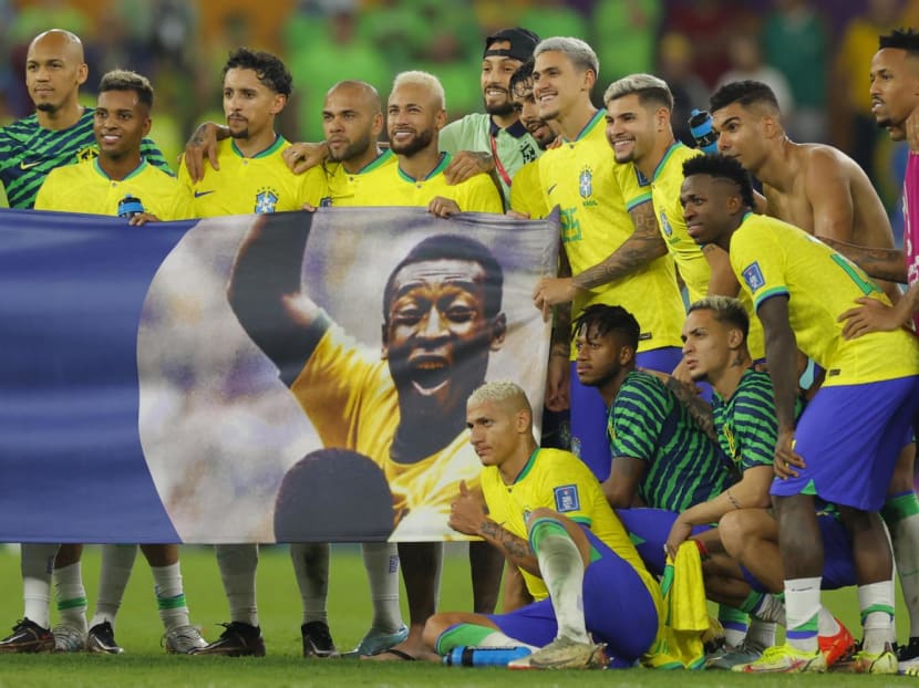 Brazil players stand behind a banner honouring Brazilian football legend Pele after they won the Qatar 2022 World Cup round of 16 football match between Brazil and South Korea at Stadium 974 in Doha on Dec 5, 2022.
