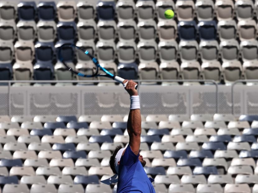 Italy's Fabio Fognini hits a return against France's Benoit Paire during their group C men's singles tennis match on day two of the 2021 ATP Cup in Melbourne on Feb 3, 2021.