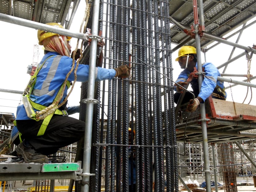 Construction workers working at a construction site, Jan 15, 2015. Photo: Ernest Chua