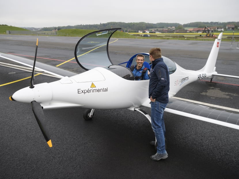 Initiator of the solar-powered stratospheric SolarStratos plane project Raphael Domjan (right) shaking hands with test pilot Damian Hischier after the first test flight on May 5, 2017 in Payerne, western Switzerland. Photo: AFP