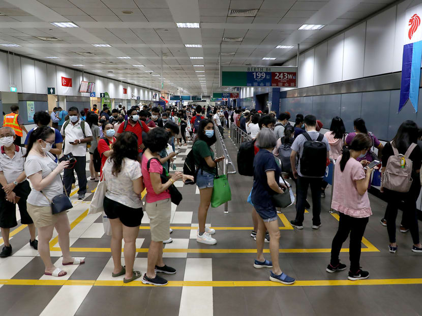 Commuters at Boon Lay Bus Interchange, one of eight bus interchanges that have been identified as active Covid-19 clusters as of Aug 30, 2021.