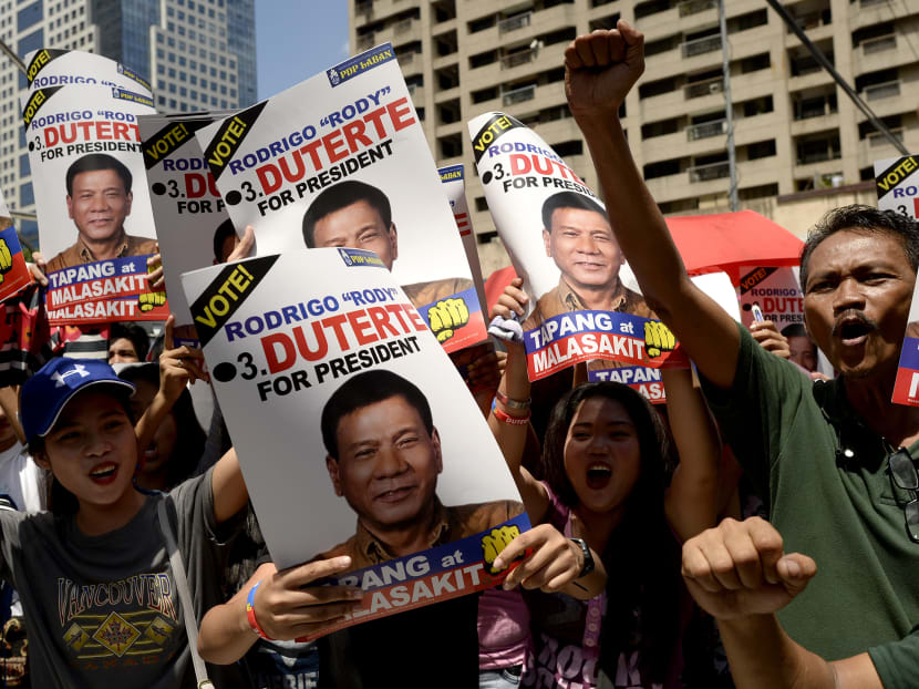 Supporters of Presidential candidate and Davao Mayor Rodrigo Duterte hold a protest near the premises of the Bank of the Philippine Island (BPI) in Manila on May 2, 2016. Photo: AFP