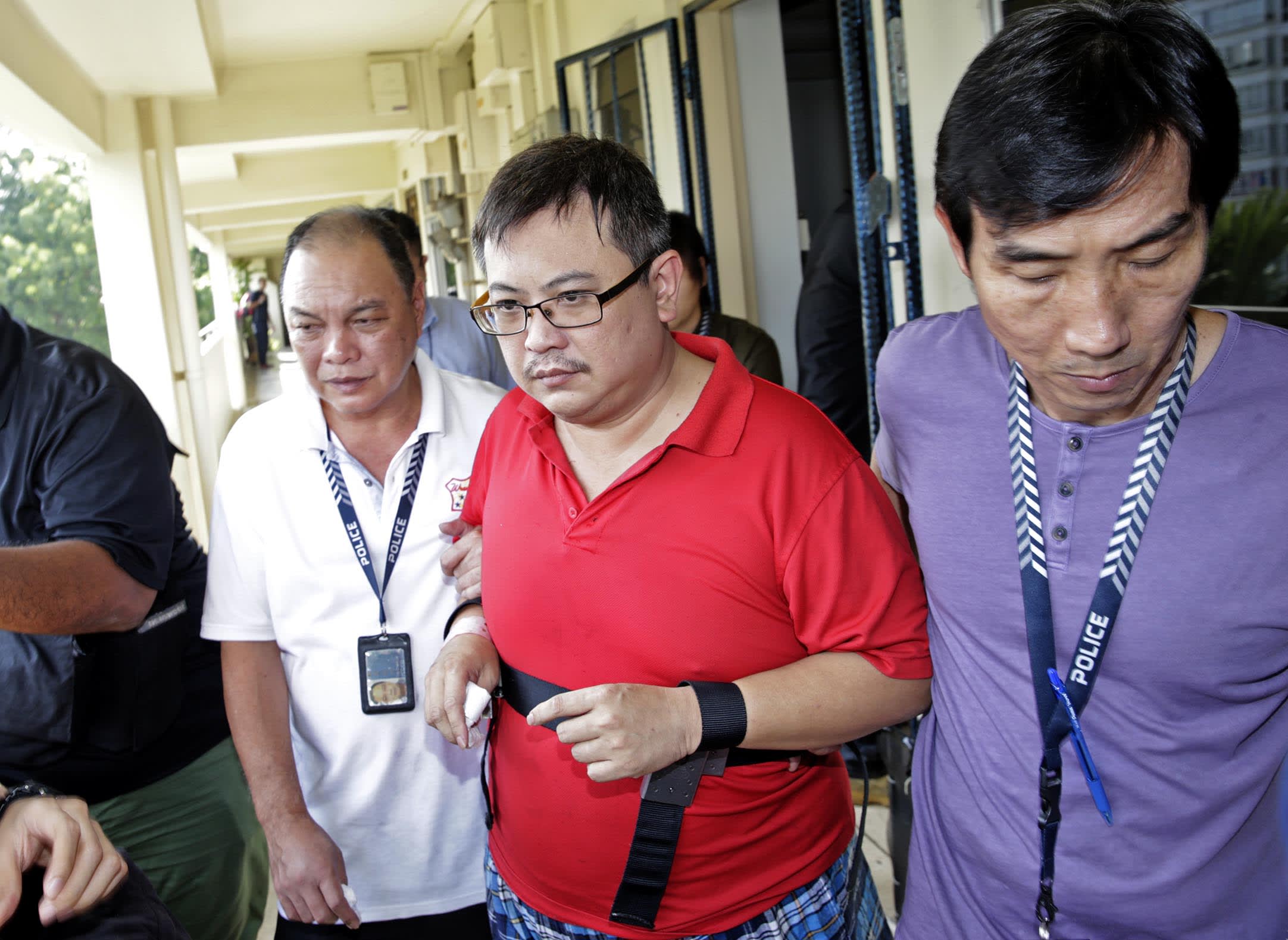 Woodlands murder suspect Teo Ghim Heng (second from right) being escorted back to the crime scene on Feb 10, 2017. Woodlands murder suspect Teo Ghim Heng (second from right) being escorted back to the crime scene on Feb 10, 2017.