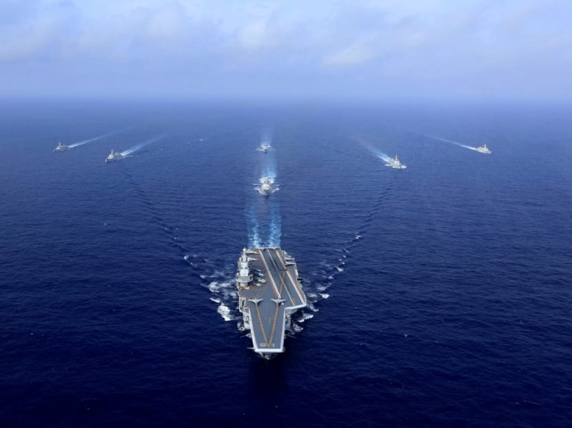 This file photo taken on April 18, 2018 shows China's aircraft carrier, the Liaoning (centre), sailing during a drill at sea. China's accelerated military modernisation poses a clear and growing threat to Taiwan, and US intervention might only risk intensifying pressure from Beijing, US defence officials told reporters on March 15, 2021.