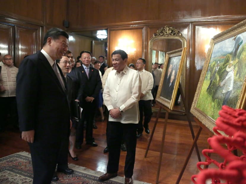 President Rodrigo Duterte presents an artwork to Chinese President Xi Jinping following a bilateral meeting in Manila on Nov 20, 2018.