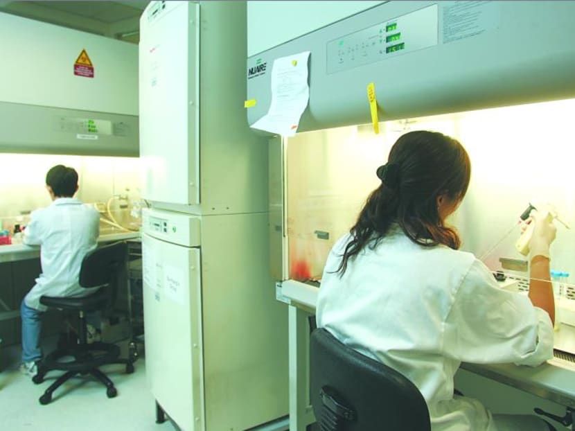 Researchers doing their work in an A*Star lab at Biopolis. Photo: Trevor Tan