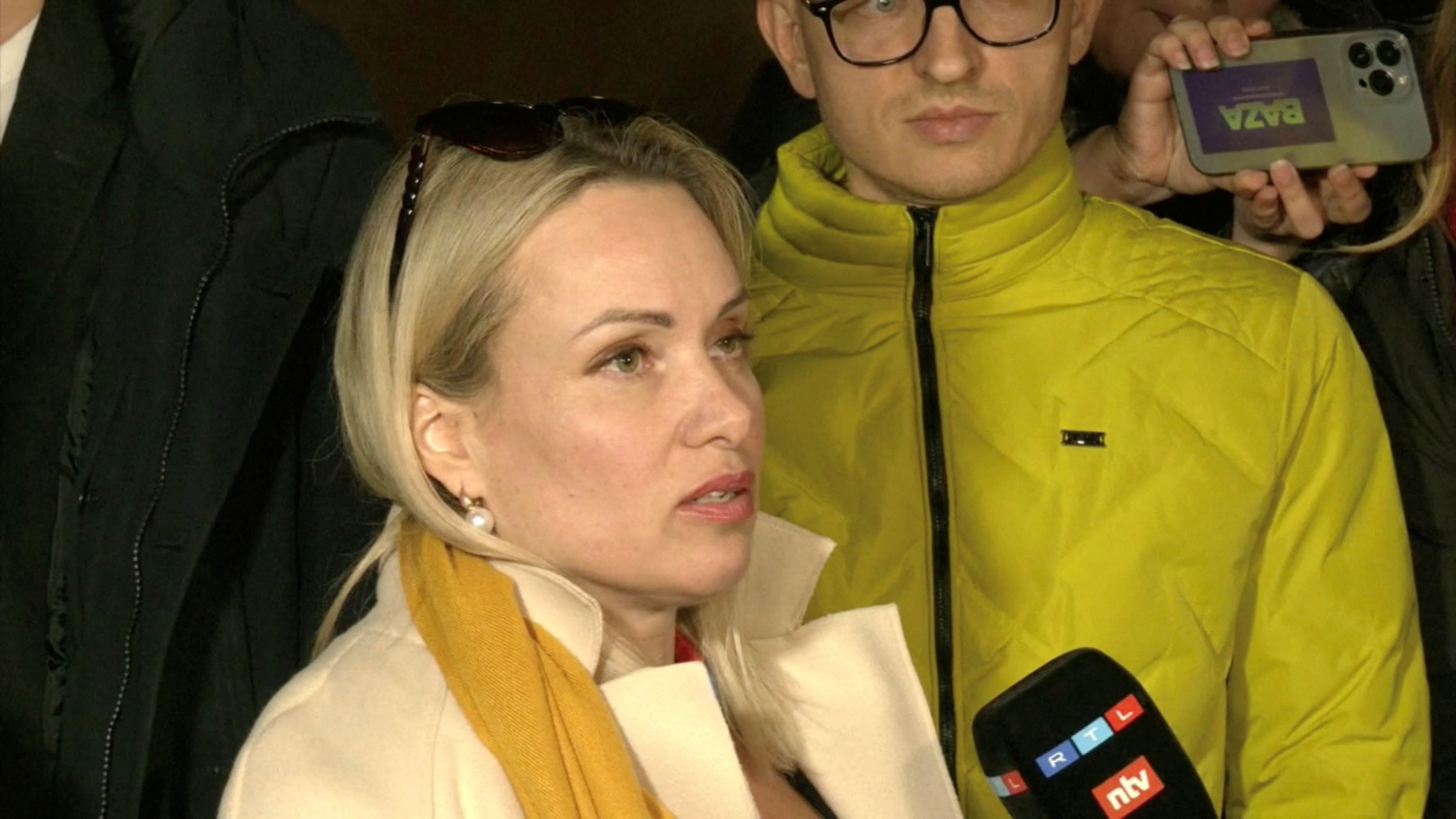 Ms Marina Ovsyannikova, a Channel One employee who staged an on-air protest as she held up an anti-war sign behind a studio presenter, speaks to the media as the leaves the court building in Moscow, Russia on March 15, 2022. 
