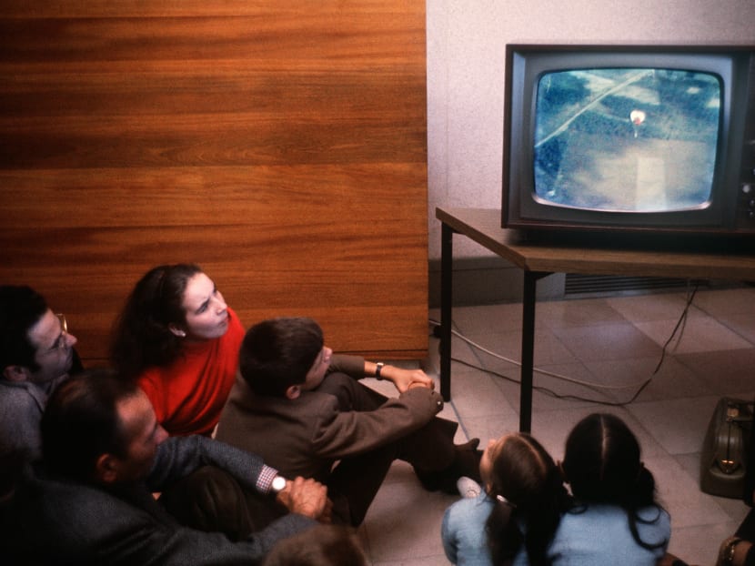 People watching television. AFP file photo
