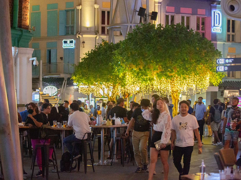 A scene at Clarke Quay on March 29, 2022, the first day that Covid-19 infection controls were eased to allow late-night drinking at eateries. A scene at Clarke Quay on March 29, 2022, the first day that Covid-19 infection controls were eased to allow late-night drinking at eateries.