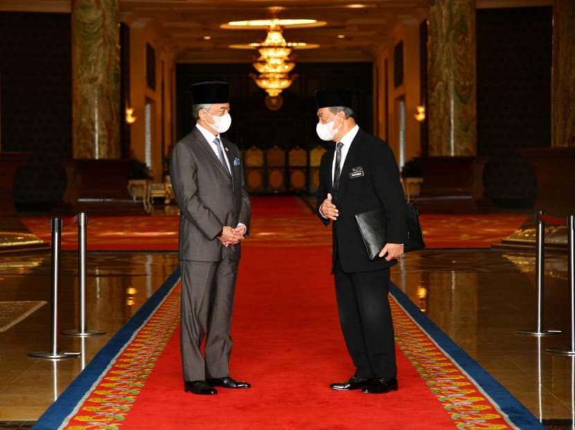 This handout picture taken and released by Malaysia's National Palace on Oct 28, 2020 shows Malaysia's prime minister Muhyiddin Yassin talking with Sultan Abdullah Sultan Ahmad Shah after their meeting at the National Palace in Kuala Lumpur.