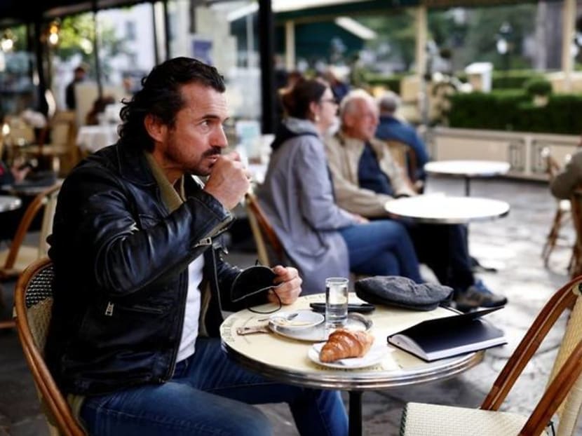 Parisians tuck into coffee and croissants again as cafes re-open Parisians tuck into coffee and croissants again as cafes re-open