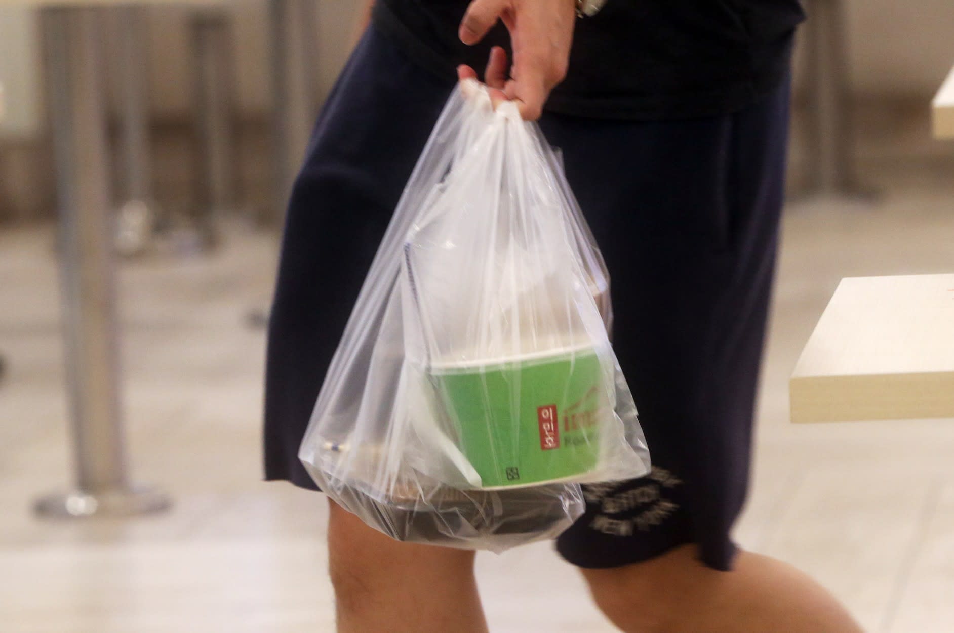 Kelvin Tan Chun Long was buying takeaway food at a coffee shop when he got angry that a hawker assistant could not redo his order that she got wrong. Kelvin Tan Chun Long was buying takeaway food at a coffee shop when he got angry that a hawker assistant could not redo his order that she got wrong.