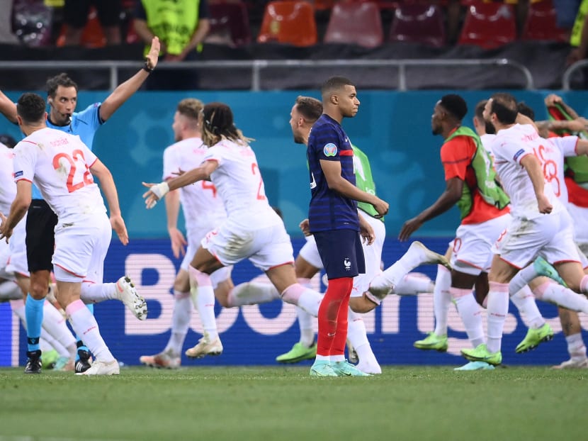 France's forward Kylian Mbappe (centre) reacts after missing a penalty during the Euro 2020 round of 16 football match between France and Switzerland at the National Arena in Bucharest, Romania on June 28, 2021.
