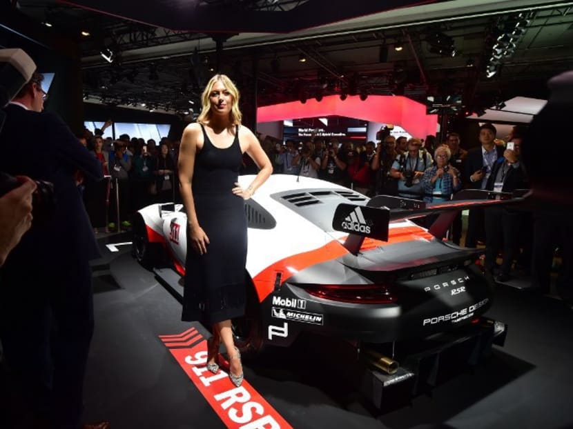 Maria Sharapova posing with the Porsche 911 RSR at the Automobility LA Press & Trade Days and Connected Car Expo in Los Angeles, California on Nov 16, 2016.  Porsche is one of her many sponsors. Photo: AFP