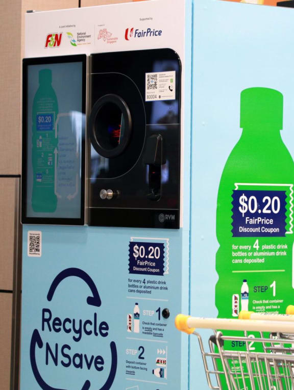 A reverse vending machine at a supermarket that accepts empty aluminium drink cans and plastic drink bottles for recycling, in return for a 20-cent supermarket discount voucher.
