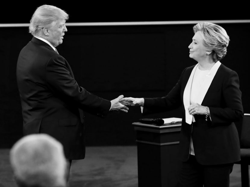 Republican presidential nominee Donald Trump and his Democratic counterpart Hillary Clinton at the end of their second presidential town hall debate at WashingtonUniversity on Oct 9. Photo: REUTERS