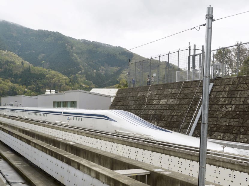 A magnetically levitating train operated by Central Japan Railway Co making a test run is seen on an experimental track in Tsuru, Yamanashi Prefecture, in this photo taken by Kyodo April 21, 2015. Photo: Reuters/ Kyodo